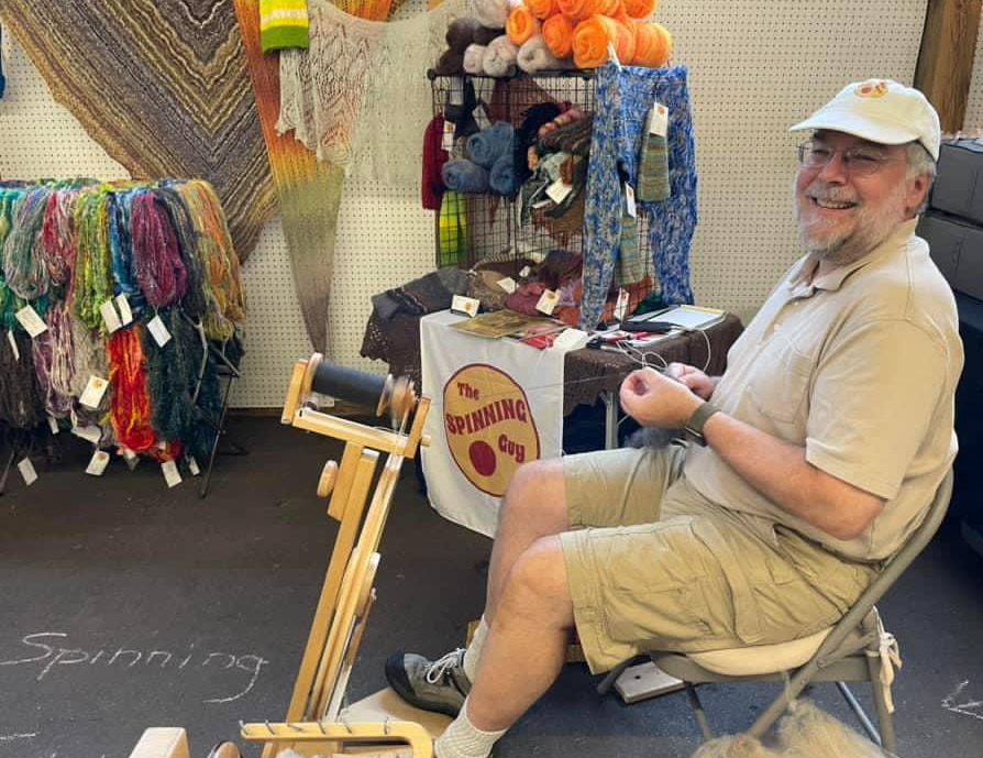 The Spinning Guy in his booth at Michigan Fiber Festival 2023